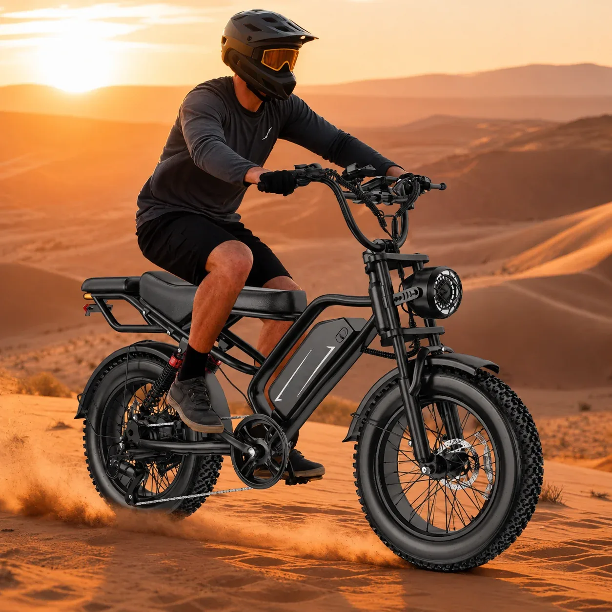 Rider on a Calder electric bike crossing desert dunes at sunset